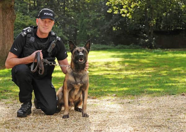 Sgt Brendan Close with his Belgium Shepherd Merlin who is four years old.

Picture: Sarah Standing