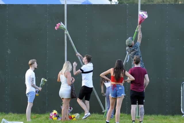Youngsters leave floral tributes to Tommy Cowan and Georgia Jones
Picture by  Malcolm Wells (180527-5966)