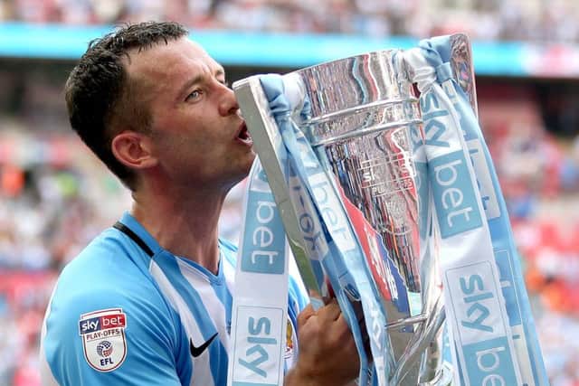 Coventry City's Michael Doyle celebrates with the trophy after the League Two Final at Wembley.
