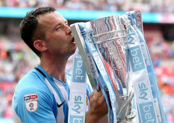 Coventry City's Michael Doyle celebrates with the trophy after the League Two Final at Wembley.