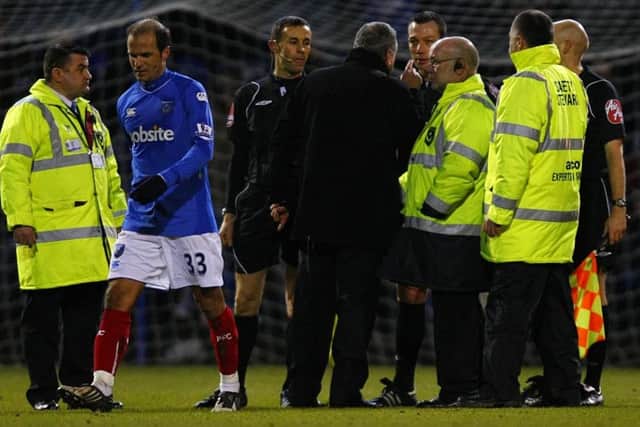 Pompey boss Avram Grant confronts referee Kevin Friend on the Fratton Park pitch at half-time in 2010