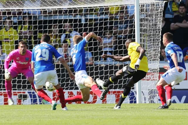 Lucas Akins scores Burton's second goal in a 2-0 defeat for Pompey at the Pirelli Stadium in 2014