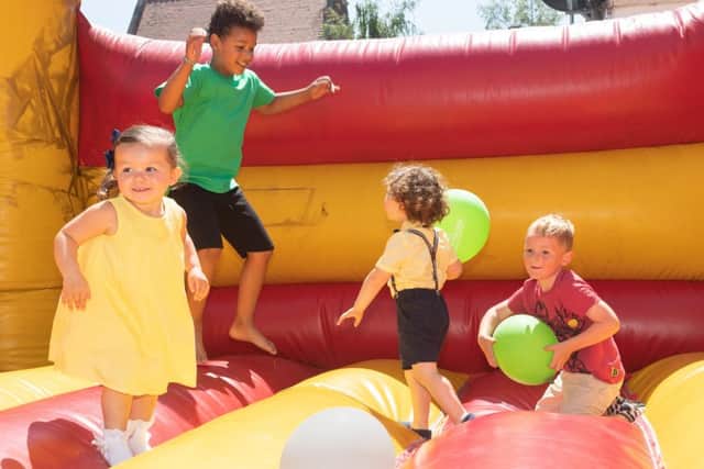 Children enjoy the bouncy castle.  Picture Credit: Keith Woodland 180302-12