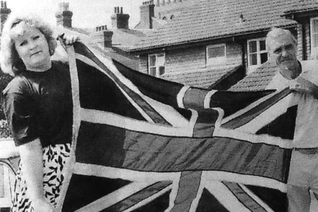 jpns 020618 retroFlag - Karen Moon-Maestri and her father Sidney Moon, 66, show the correct way for the Union Jack to be flown