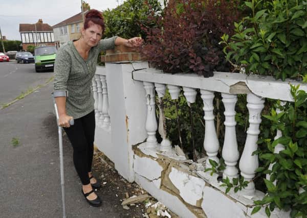 Crina Parker who is upset after a car crashed into her wall at her home in Gosport.

Picture Ian Hargreaves  (180491-1)