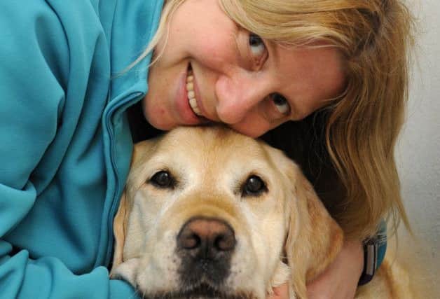 Pet Hospital manager Sam Haig with 'Harry' a lovable Golden Labrador. Picture: Malcolm Wells (180530-1056)