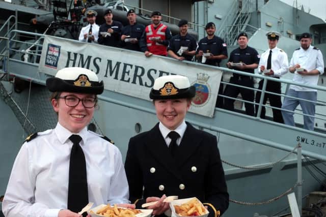 Some of HMS Mersey's crew including, at the front, SLt Alex Steeples (white shirt) and SLt Lucy Carmichael. Royal Navy sailors from the Fishery Protection Squadron celebrate National Fish and Chips Day Picture: Chris Moorhouse