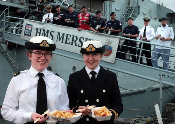 Some of HMS Mersey's crew including, at the front, SLt Alex Steeples (white shirt) and SLt Lucy Carmichael. Royal Navy sailors from the Fishery Protection Squadron celebrate National Fish and Chips Day Picture: Chris Moorhouse