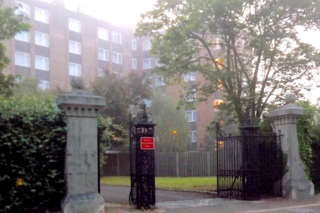 NOW: The gate remains with the Holiday Inn replacing the former clock tower at the barracks.