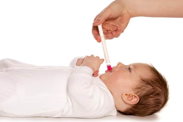 A baby being given Calpol.