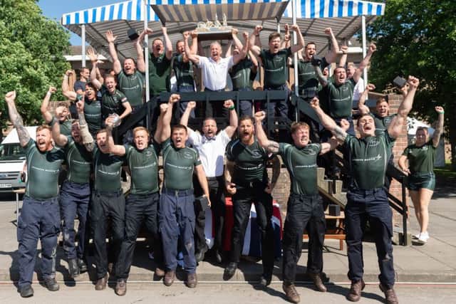 Eventual winners HMS Heron celebrate their win of the Brickwood's Field Gun Trophy. Picture Credit: Keith Woodland
