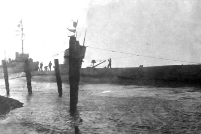 This postcard's caption says: 'Submarine H23 stranded in the mud at Point, Old Portsmouth.' But  Mike Nolan thinks it is off the Round Tower.