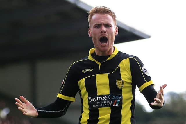 Tom Naylor celebrates his goal which sealed Burton Albion's unlikely promotion to the Championship