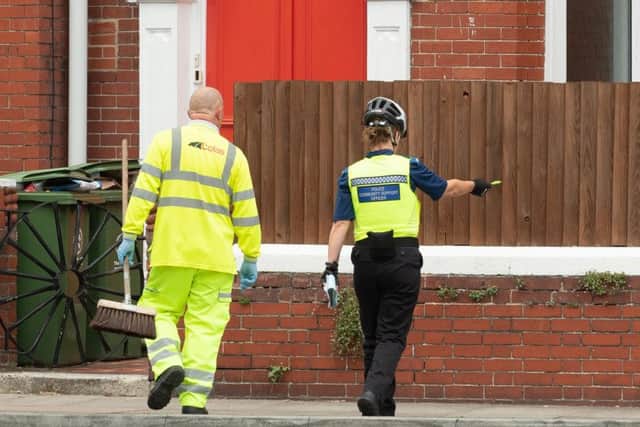 A council employe is directed by a PCSO during the clean up after the event.
Picture Credit: Keith Woodland PPP-181006-142125006