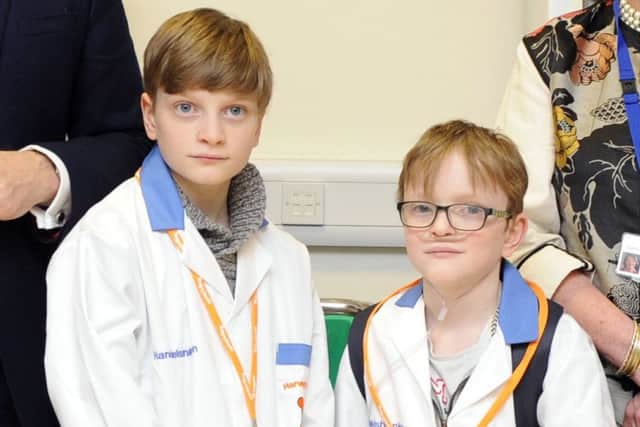 Sam Merrick, right, with his brother Liam during a visit to QA Hospital
