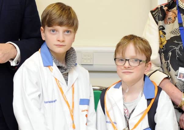 Sam Merrick, right, with his brother Liam during a visit to QA Hospital