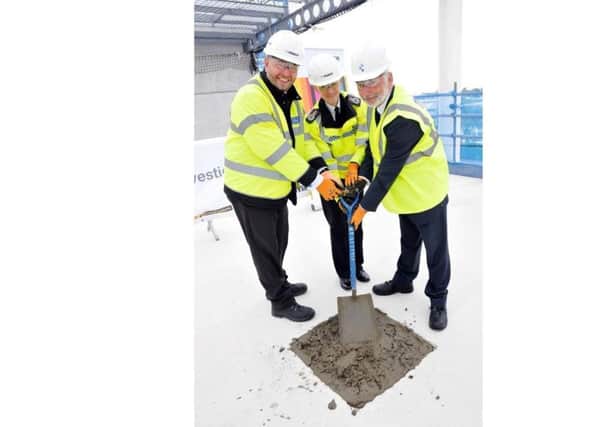 A topping out ceremony was held for the new police investigation centre in Portsmouth. (L to R) James Payne, Police and Crime Commissioner's chief executive, Chief Constable Olivia Pinkney and PCC Michael Lane.
