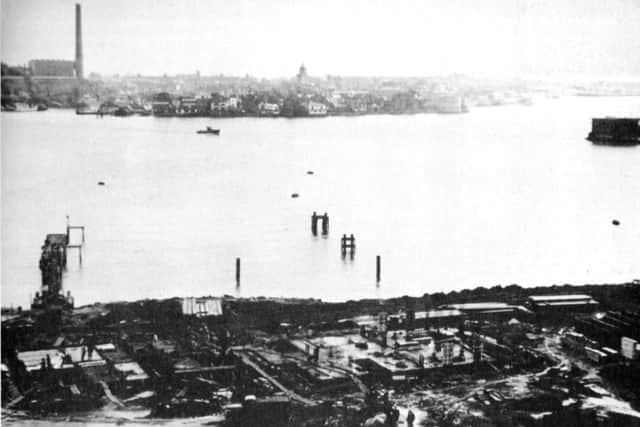 Portsmouth Harbour is noted for its busy-ness and that there is always something going on. Just one small motor boat proves the point in this picture. It must have been early in the morning when the Evening News photographer took this photograph. In the foreground are the foundations of the tower blocks at Gosport.