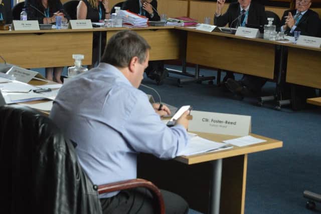 Cllr Clive Foster-Reed using his phone throughout a Gosport Borough Council planning meeting. Picture: David George