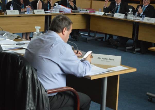 Cllr Clive Foster-Reed using his phone throughout a Gosport Borough Council planning meeting. Picture: David George
