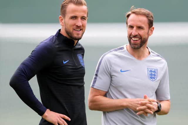 England boss Gareth Southgate, right, and skipper Harry Kane share a joke in training ahead of the World Cup