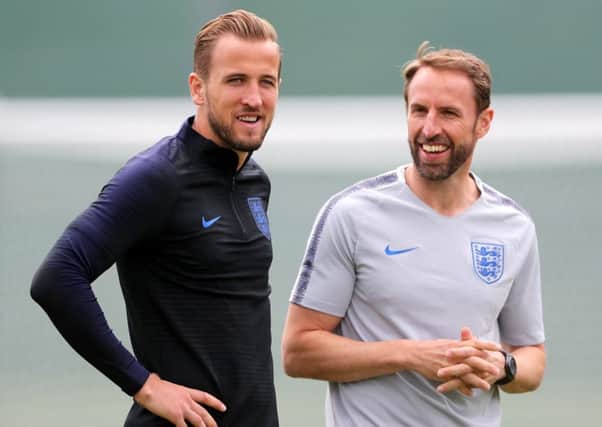 England boss Gareth Southgate, right, and skipper Harry Kane share a joke in training ahead of the World Cup