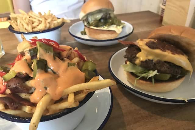 6oz Burgers in Osborne Road, Southsea. The smoked sausage burger, accompanied by bacon and three cheese loaded fries