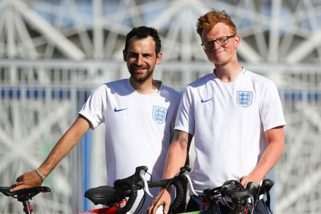 Jamie Marriott, 28, and Mitchell Jones, 24, right, outside the Volgograd Arena in Volgograd after cycling from Emsworth Picture: Aaron Chown/PA Wire