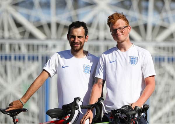 Jamie Marriott, 28, and Mitchell Jones, 24, right, outside the Volgograd Arena in Volgograd after cycling from Emsworth Picture: Aaron Chown/PA Wire
