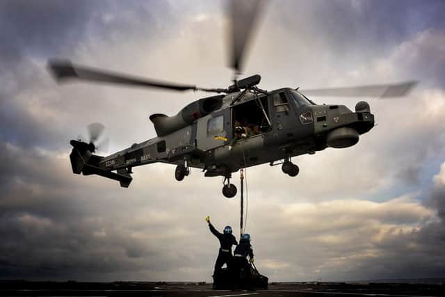 The Wildcat on board HMS Dragon delivers stores to RFA Lyme Bay during Exercise Catamaran