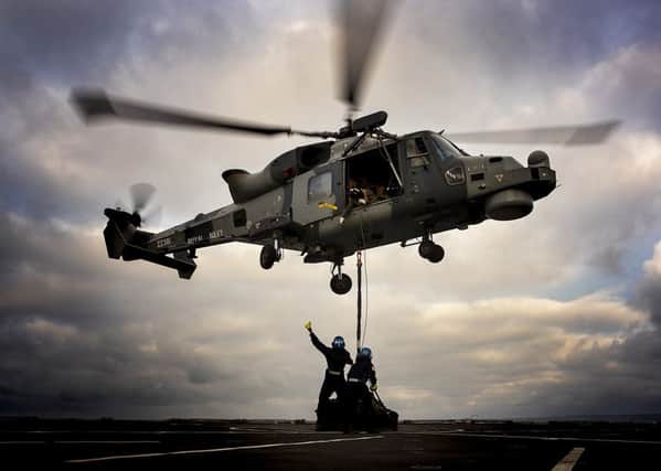 The Wildcat on board HMS Dragon delivers stores to RFA Lyme Bay during Exercise Catamaran