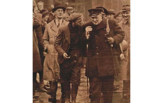 Arthur Beech speaking to Sir Winston Churchill in Portsmouth Dockyard in 1941 - with the prime minister sporting the cane up for sale in his left hand. Picture: The News archive
