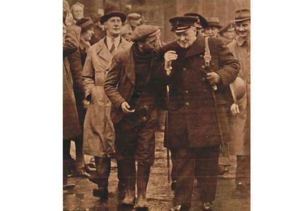 Arthur Beech speaking to Sir Winston Churchill in Portsmouth Dockyard in 1941 - with the prime minister sporting the cane up for sale in his left hand. Picture: The News archive