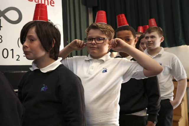 Children taking part in a balancing game at HMS Excellent