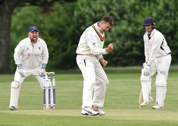 Archie Reynolds celebrates a wicket with James Scutt, left. Picture: Neil Marshall (180616_020)