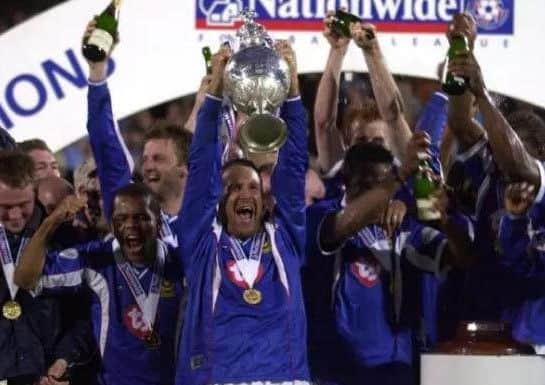 Paul Merson holds aloft the 2002-03 Championship winners trophy