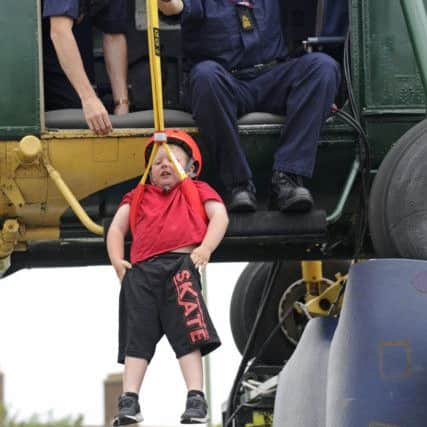 Lincoln Voller-Sutton, five, from Gosport is winched from the helicopter