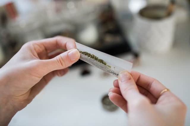 A woman rolls a cannabis cigarette. Picture: Flickr (labelled for reuse)