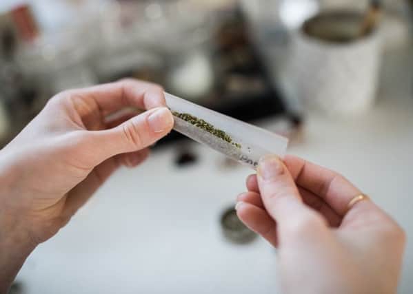 A woman rolls a cannabis cigarette. Picture: Flickr (labelled for reuse)
