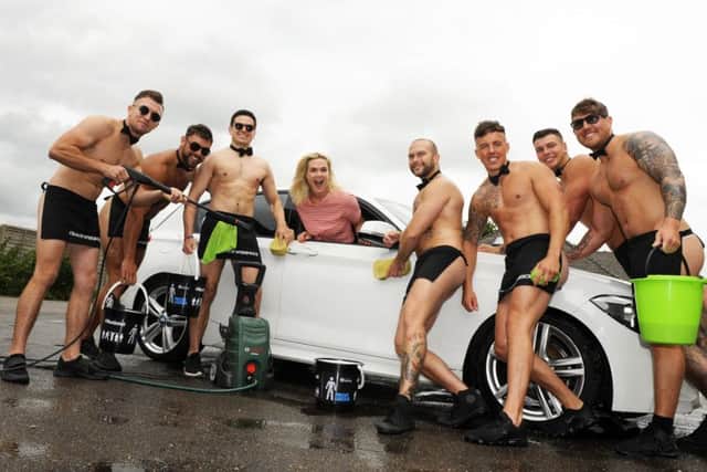 Michaela Shaw 
has her car washed by the so-called 'Naked Butlers' in Emsworth. Picture: Malcolm Wells