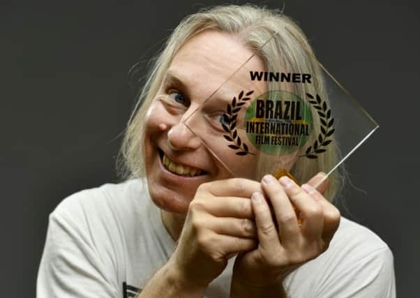 Gavin Irvine with his Best Short Film award, from the Brazil International Film Festival. Picture by Geoff Pugh