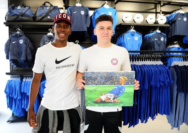 Pompey player Jamal Lowe with Sam Parrott, from Fareham, who celebrated his 18th birthday on the day of the new shop opening
Picture: Sarah Standing (180528-7595)