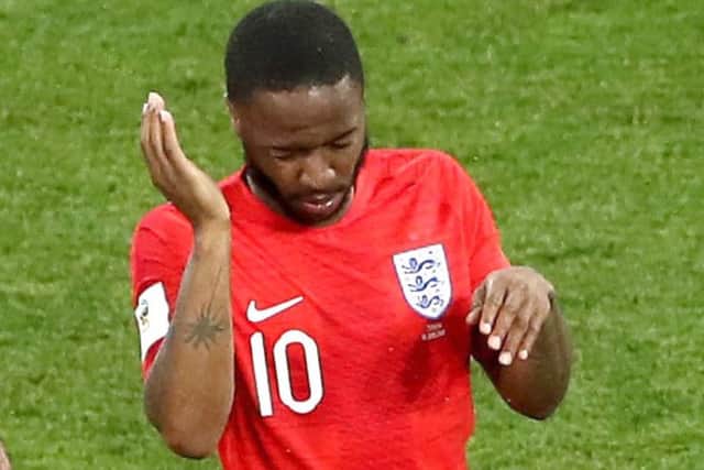 England's Raheem Sterling swats away insects in Volgograd on Monday