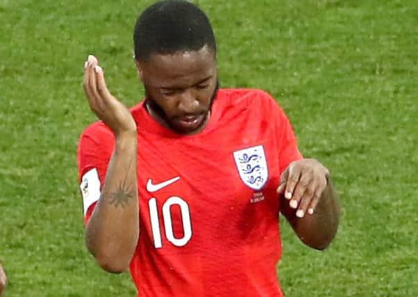 England's Raheem Sterling swats away insects in Volgograd on Monday