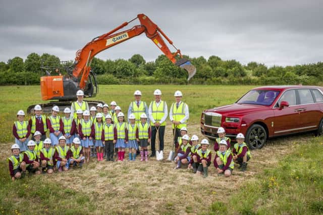 Members of the Rolls-Royce Motor Cars board of directors with pupils from March CE Primary School From left to right: Frank Ludwig (director of manufacturing), Richard Carter (director of global communications), Torsten Müller-ötvös (chief executive officer) and Juergen Brzank (director of finance)