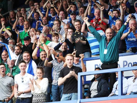 Pompey fans celebrate Pompey's 2-0 success over Rochdale on the opening day of last season.
