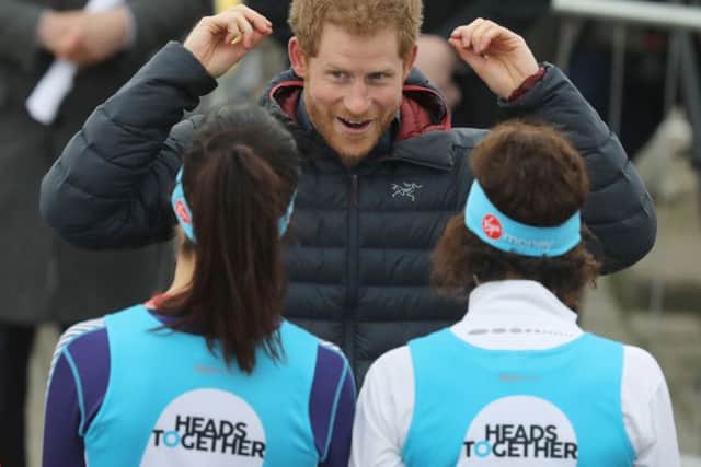 Prince Harry talking to runners taking part in the London Marathon for mental health charity Heads Together, which he founded Picture: Owen Humphreys/PA Wire