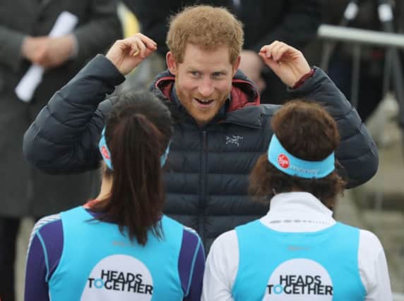 Prince Harry talking to runners taking part in the London Marathon for mental health charity Heads Together, which he founded Picture:  Owen Humphreys/PA Wire