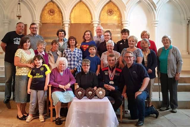 The Rev Karen Mitchell (seated, centre) with Harvey Spoor (to her right) and congregation members at St Thomas Church, Elson