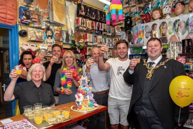 The Lord Mayor of Portsmouth, Cllr Lee Mason, and the owners and staff of the shop raise their glasses to celebrate 95 years of U-Need-Us  Picture: Vernon Nash (180396-006)